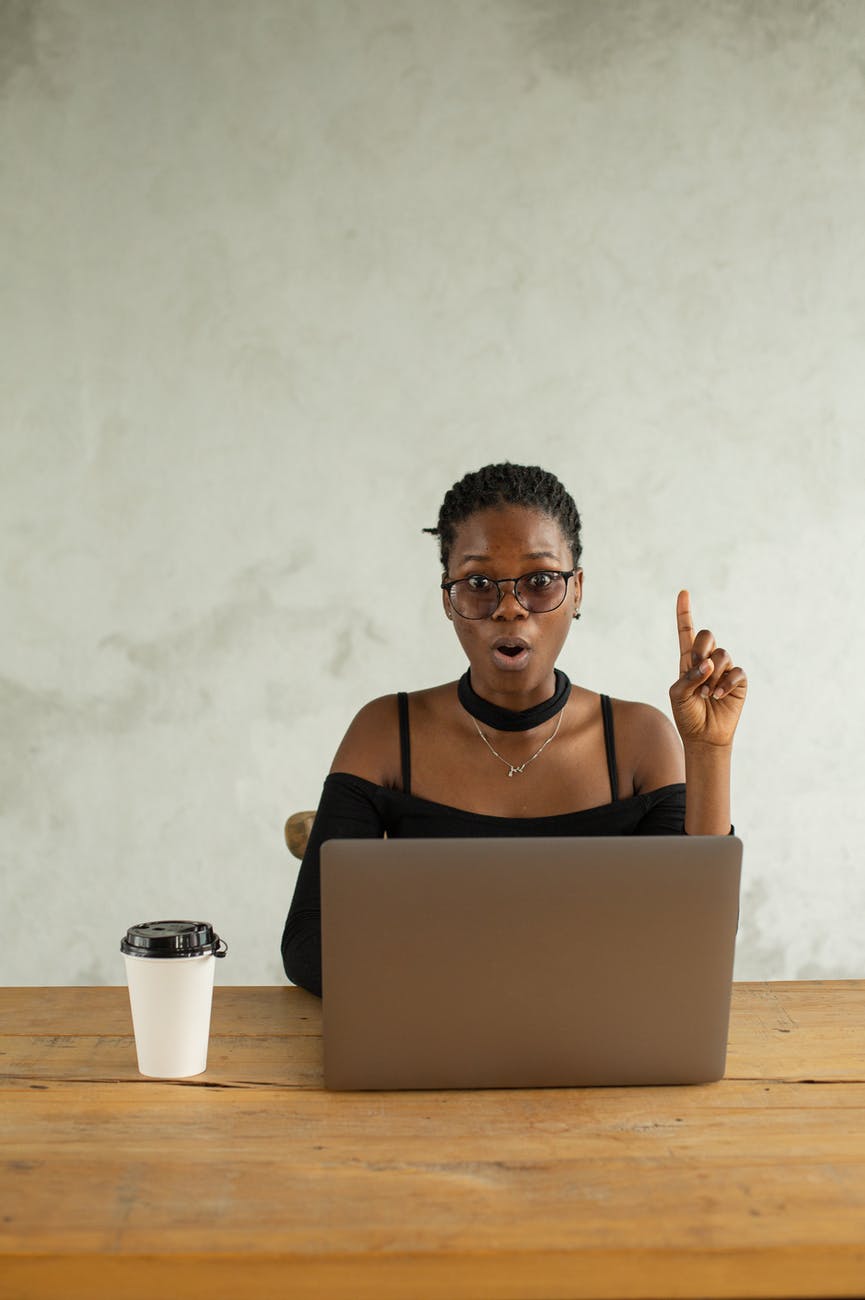 excited black woman using laptop